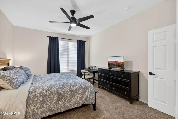 a bedroom with a bed furniture and a flat screen tv
