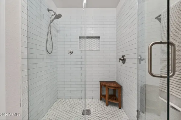 a bedroom with a bed dresser and a window