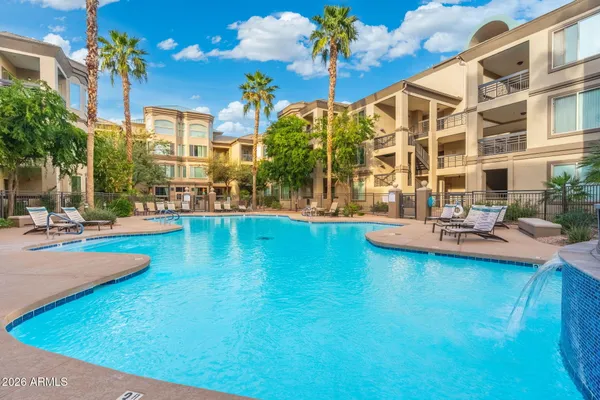 a view of a swimming pool with outdoor seating