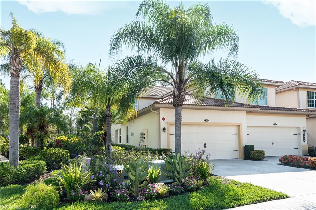 7878 Clemson Street, Unit 101 Naples, FL 34104 - Photo 1 of 18 a front view of house with yard and green space