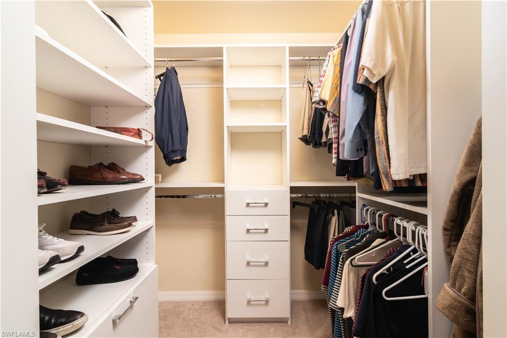 7878 Clemson Street, Unit 101 Naples, FL 34104 - Photo 13 of 18 a view of walk in closet with clothes and shoes