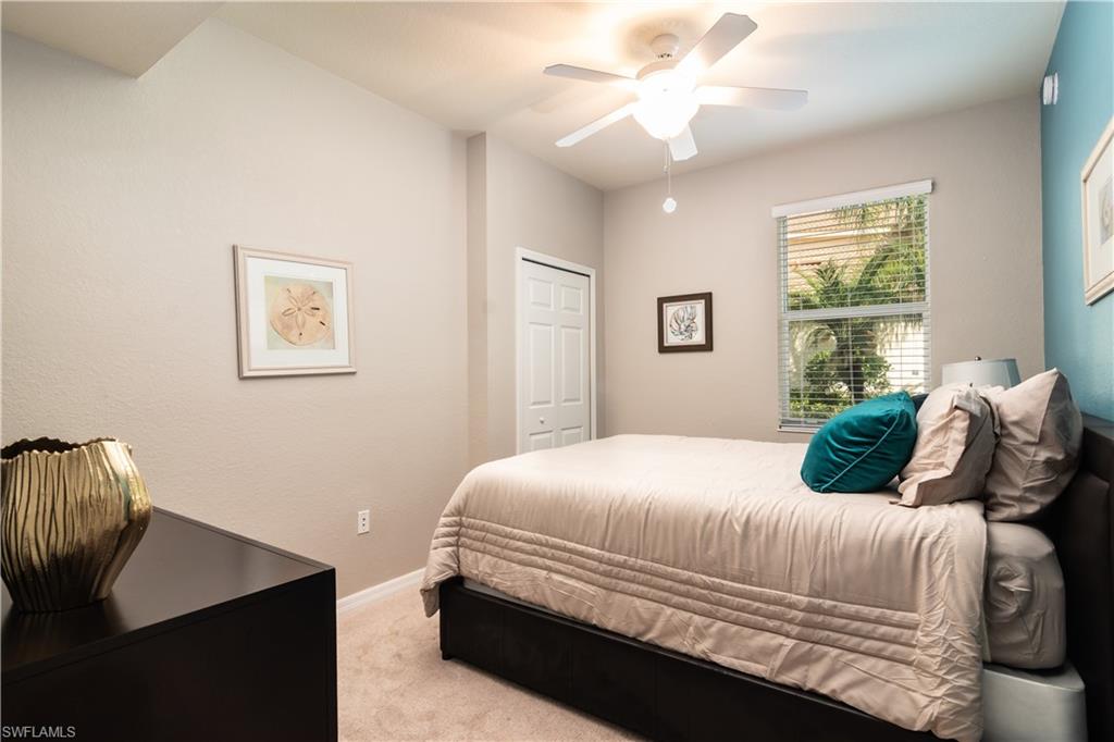 7878 Clemson Street, Unit 101 Naples, FL 34104 - Photo 14 of 18 a bedroom with a bed and a window