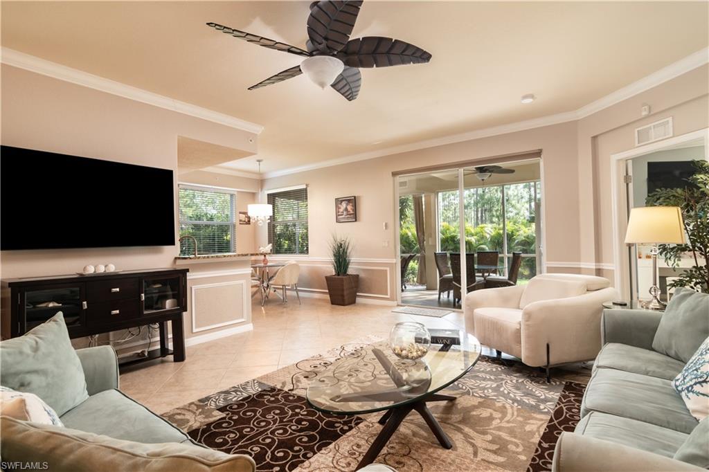 7878 Clemson Street, Unit 101 Naples, FL 34104 - Photo 3 of 18 a living room with furniture and a flat screen tv