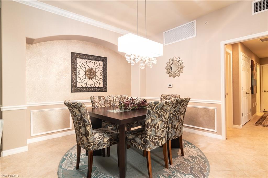 7878 Clemson Street, Unit 101 Naples, FL 34104 - Photo 4 of 18 a view of a dining room with furniture and wooden floor