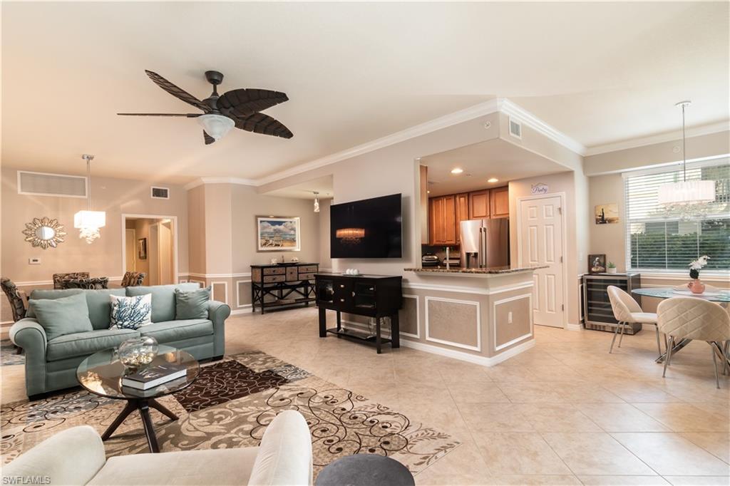 7878 Clemson Street, Unit 101 Naples, FL 34104 - Photo 5 of 18 a living room with furniture and a flat screen tv