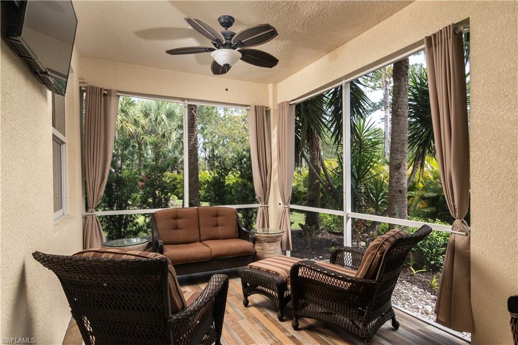 7878 Clemson Street, Unit 101 Naples, FL 34104 - Photo 8 of 18 a living room with furniture and a floor to ceiling window