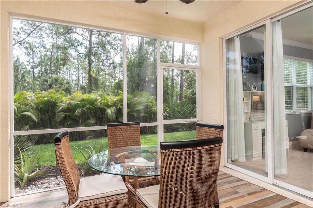 7878 Clemson Street, Unit 101 Naples, FL 34104 - Photo 9 of 18 a view of a chair and table in the balcony