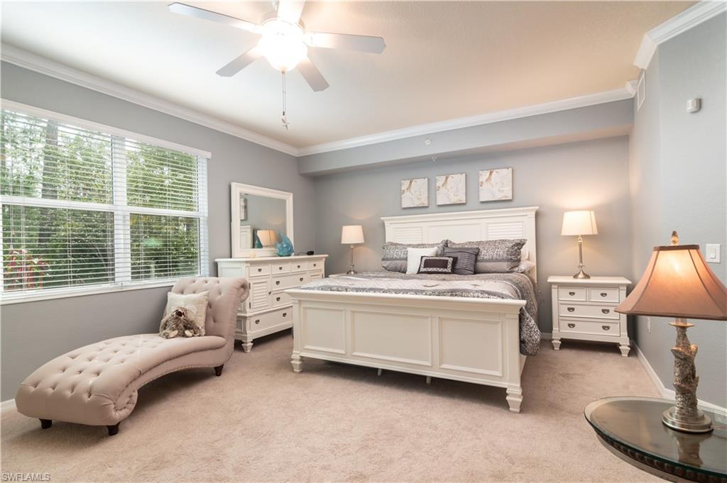 7878 Clemson Street, Unit 101 Naples, FL 34104 - Photo 10 of 18 a living room with furniture and a chandelier