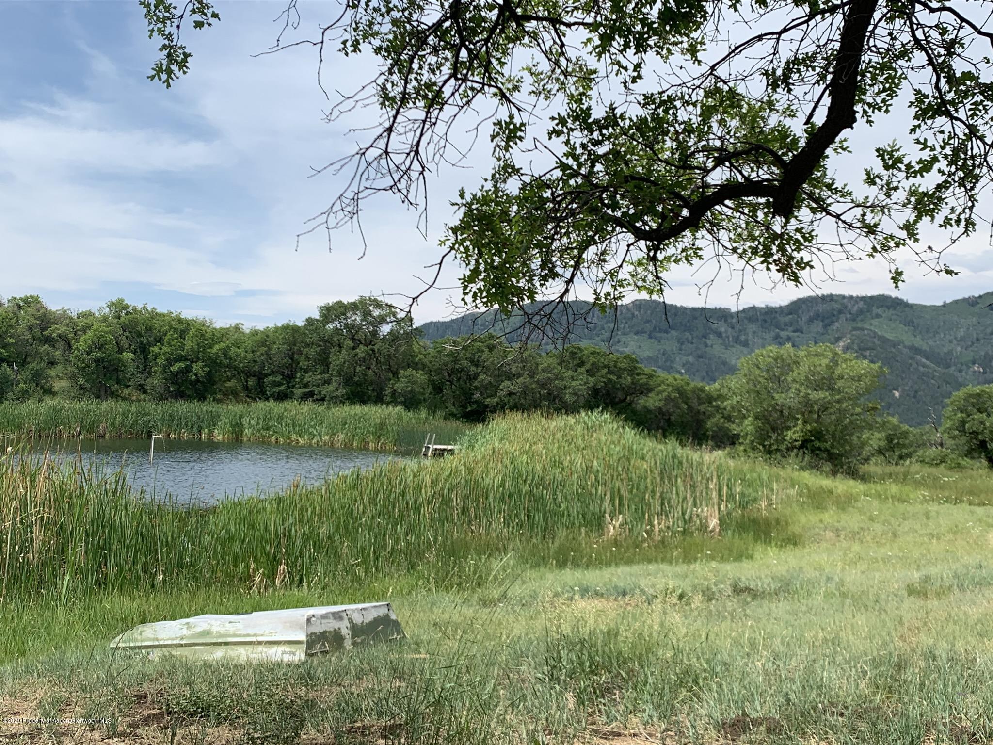 Tbd Wild Acres Ranch Road Rifle, CO 81650 - Photo 11 of 33 a view of a lake from a yard
