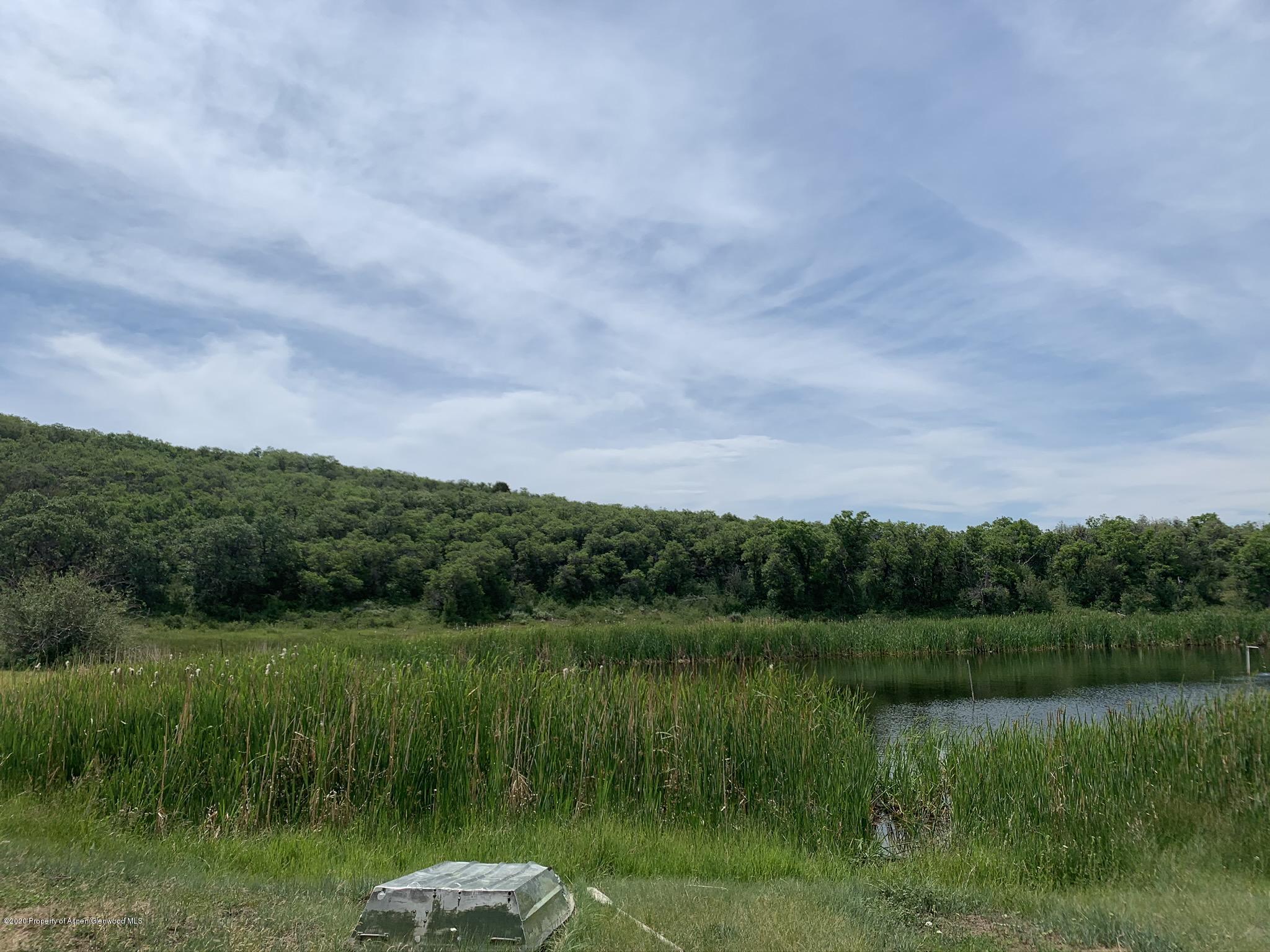 Tbd Wild Acres Ranch Road Rifle, CO 81650 - Photo 13 of 33 a view of a lake from a yard