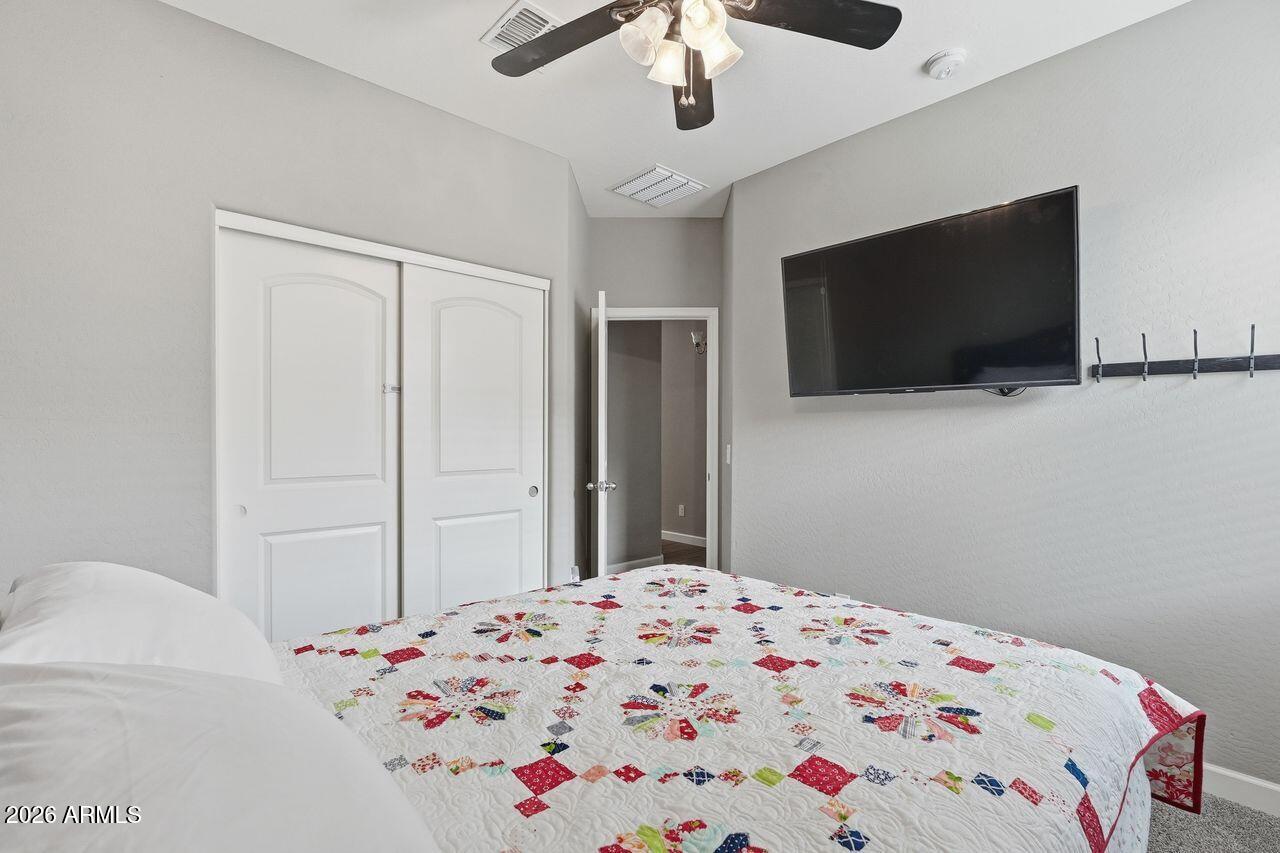 23602 West Ripple Road Buckeye, AZ 85326 - Photo 31 of 38 a bedroom with a bed and a flat screen tv