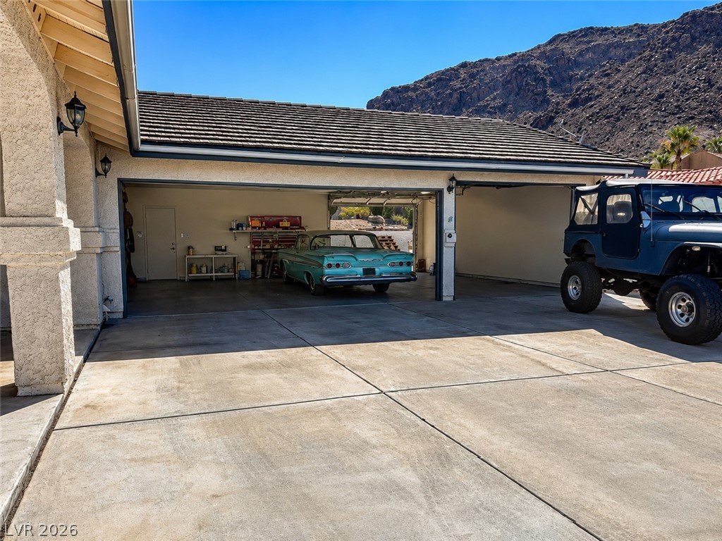 524 Swallow Cove Boulder City, NV 89005 - Photo 39 of 58 A spacious garage with ample parking offers convenience and stunning mountain views.
