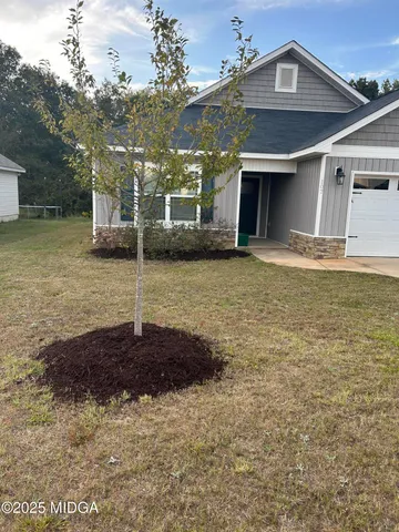 a front view of a house with a yard