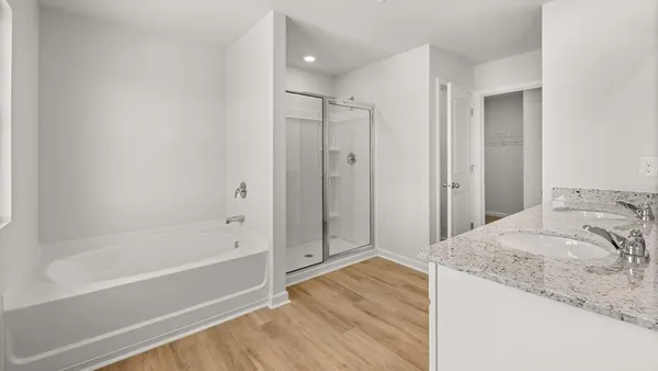 a spacious bathroom with a granite countertop tub sink and shower