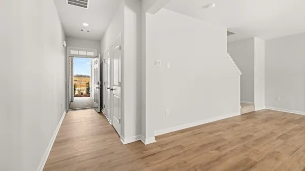 a view of a hallway with wooden floor
