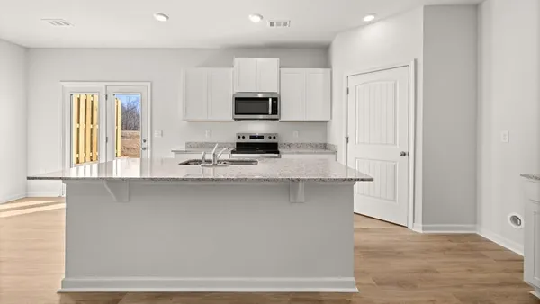a kitchen with stainless steel appliances a sink stove and microwave
