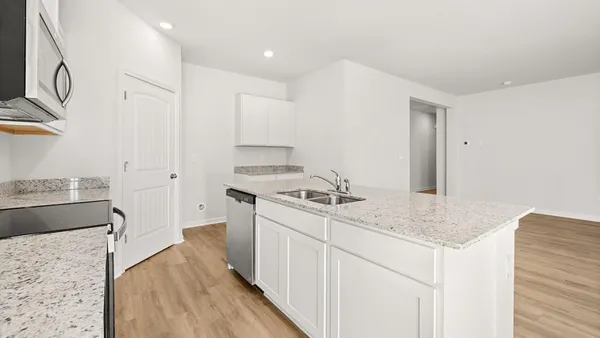 a kitchen with a sink stove and refrigerator