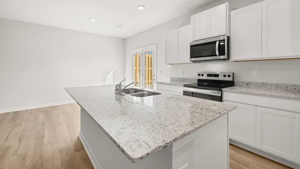 a kitchen with stainless steel appliances granite countertop a sink a microwave counter space and cabinets