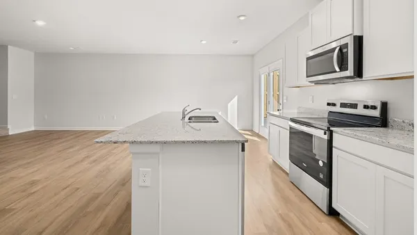 a kitchen with stainless steel appliances granite countertop a sink and cabinets