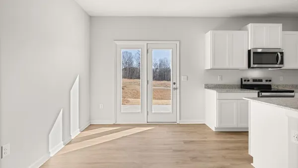 a view of a kitchen with wooden floor and a sink