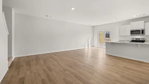 a view of kitchen with wooden floor and electronic appliances