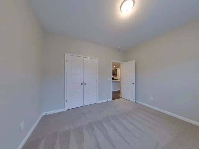 a view of an empty room and a window