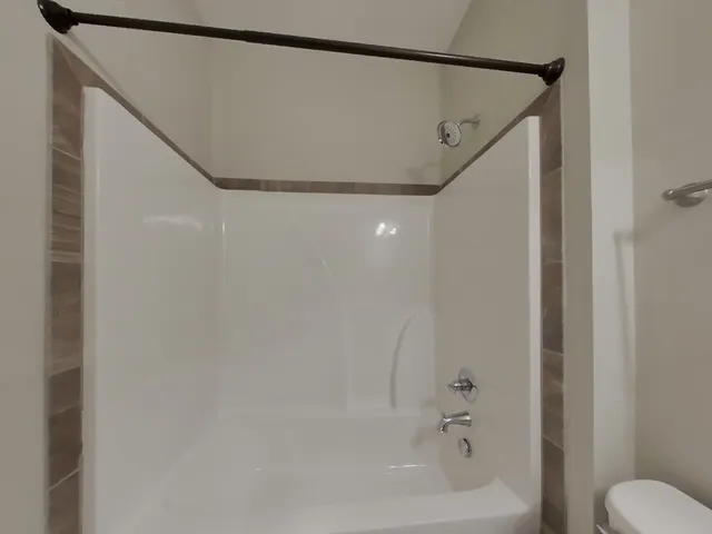 a bathroom with a shower and a toilet