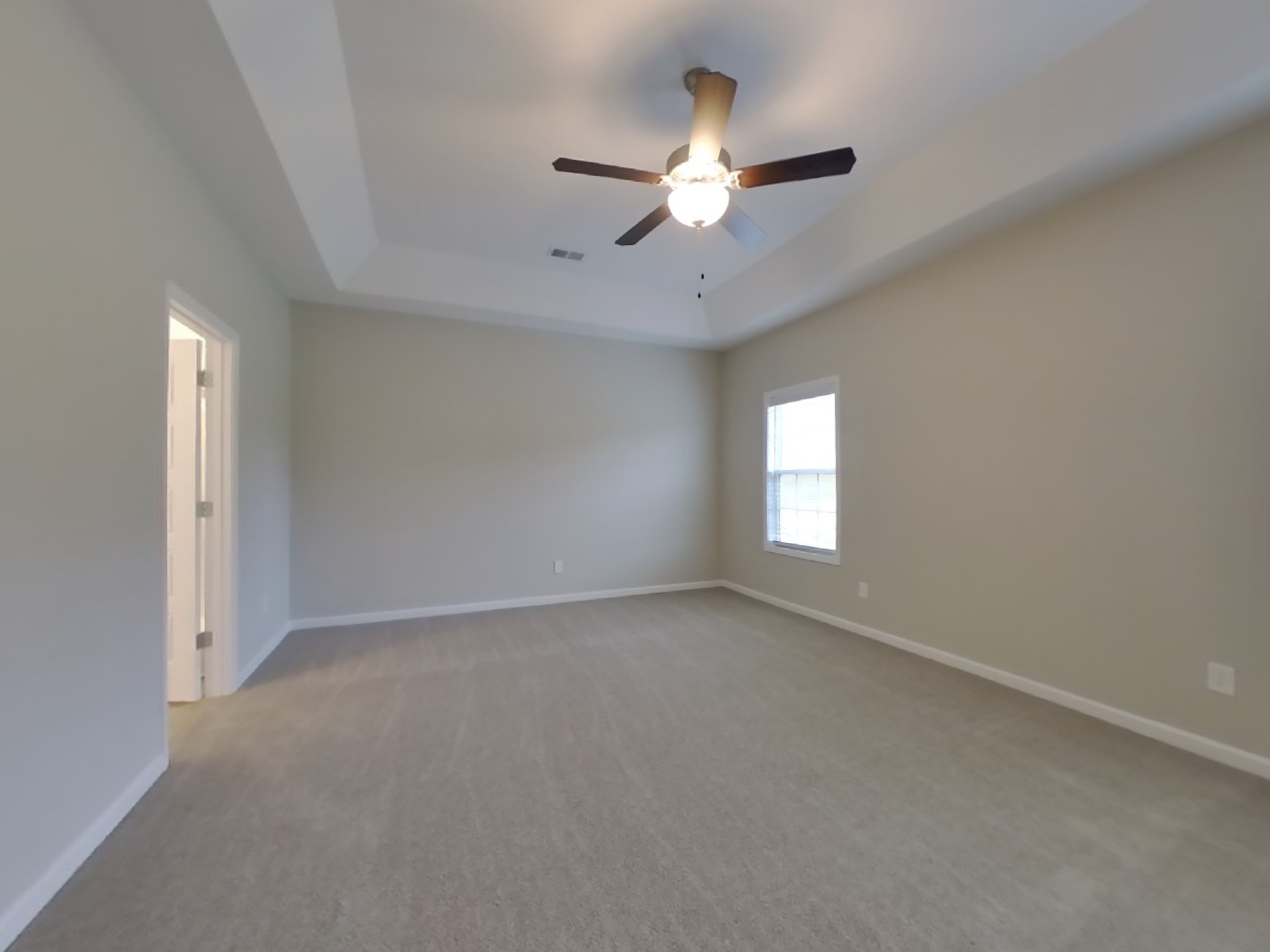 824 Ellyson Drive Spring Hill, TN 37174 - Photo 8 of 18 an empty room with a chandelier fan and windows