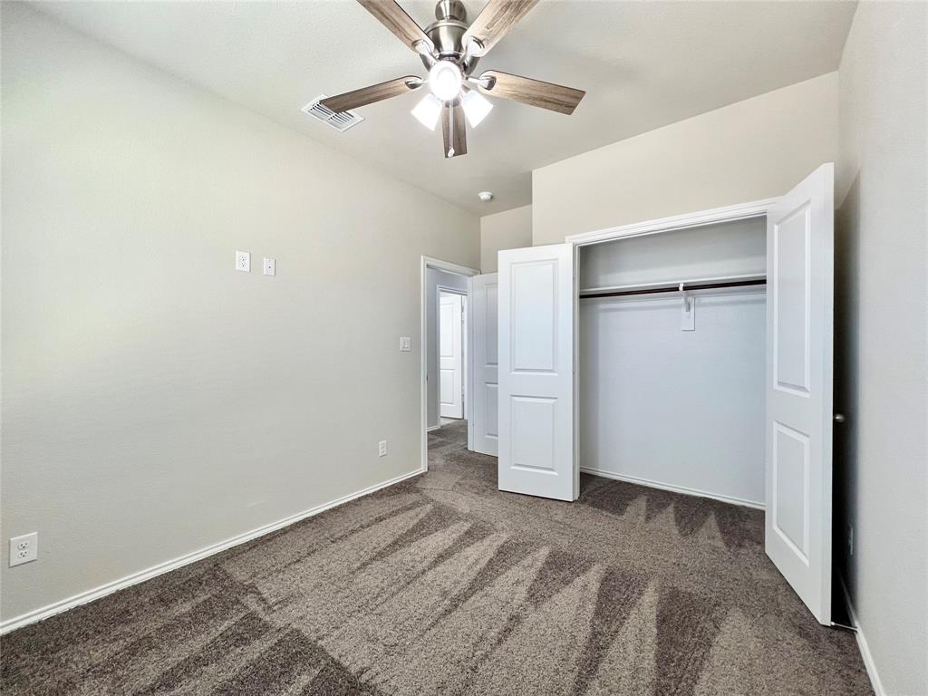 3501 East Renfro Street, Unit 611 Burleson, TX 76028 - Photo 19 of 35 2nd bedroom with carpet floors, a ceiling fan, and a closet