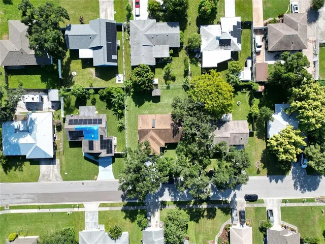 an aerial view of multiple houses with yard
