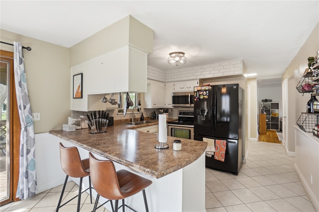 150 Littlejohn Road Troy, OH 45373 - Photo 11 of 40 This functional kitchen provides a delightful setting for culinary creativity and casual dining.