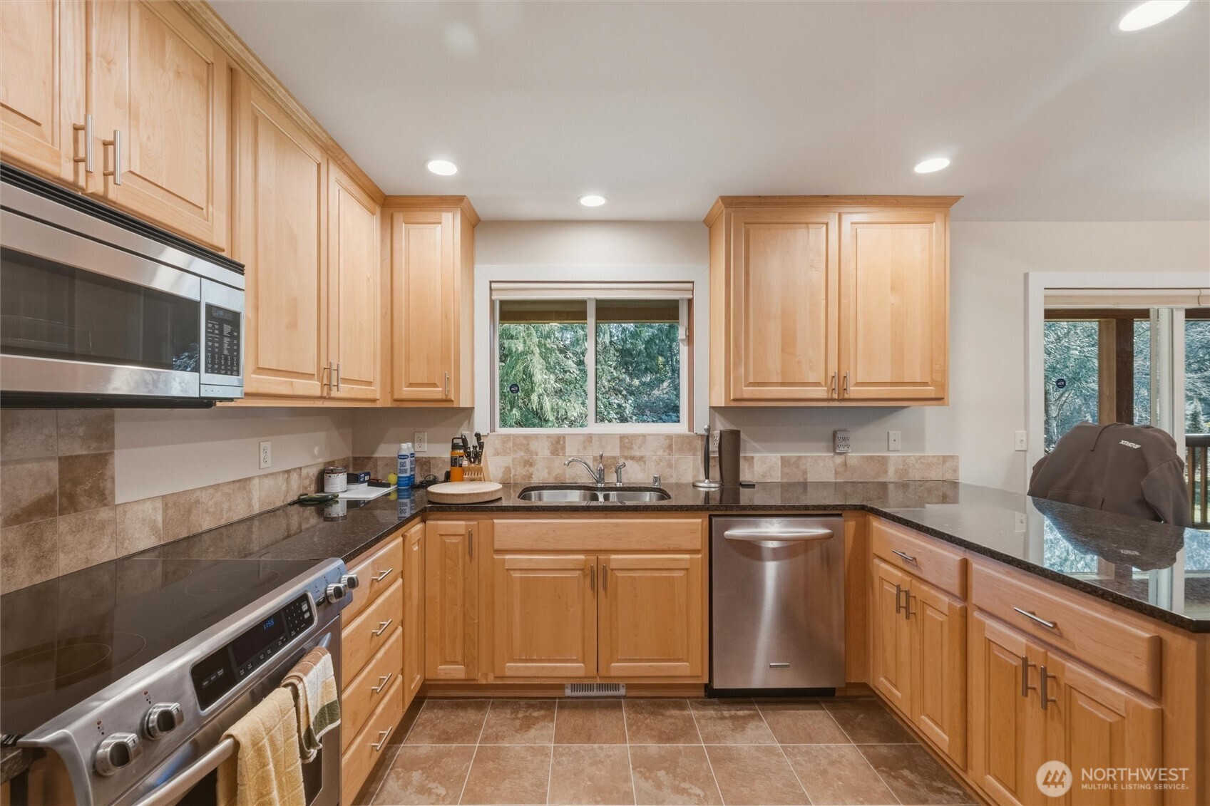 16059 Snee Oosh Road La Conner, WA 98257 - Photo 14 of 40 a kitchen with a sink stove top oven and cabinets