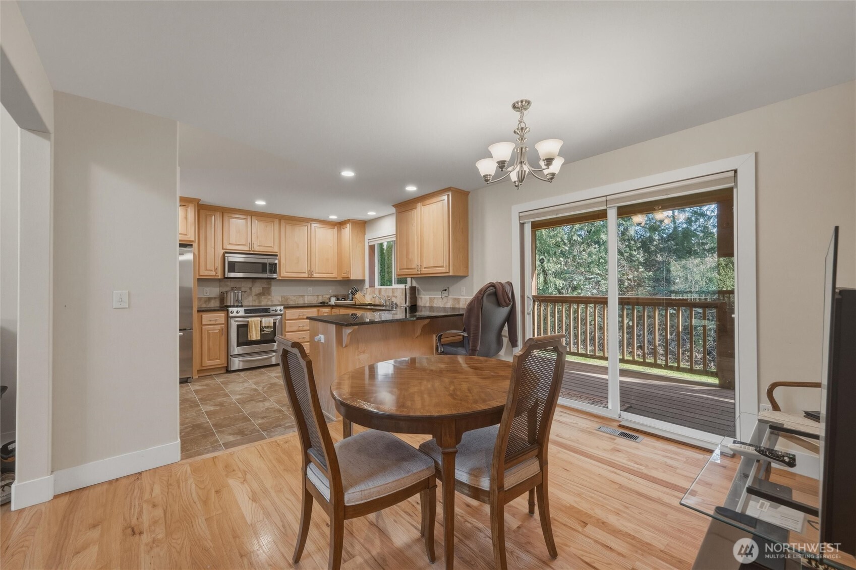 16059 Snee Oosh Road La Conner, WA 98257 - Photo 16 of 40 a view of a dining room with furniture window and wooden floor