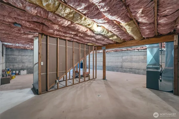a view of a wooden house with a big yard and large trees