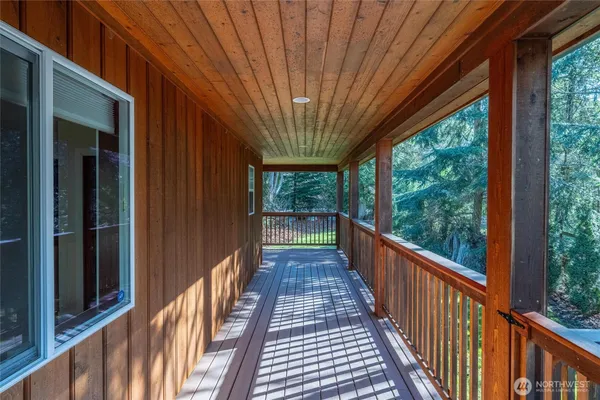 a view of a house with a small yard and wooden fence