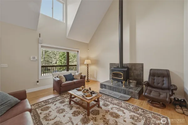 a living room with furniture and a table with wooden floor