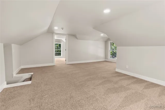 an empty room with windows and entrance