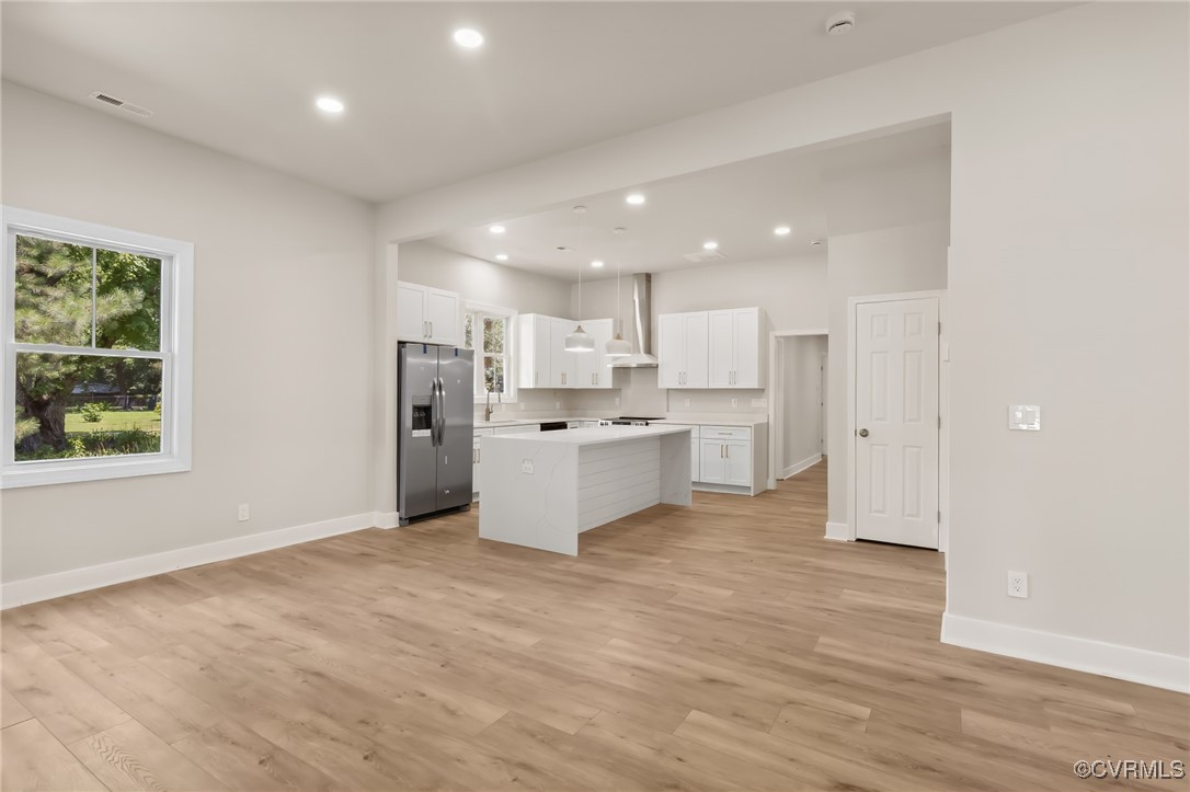 10614 Rives Avenue McKenney, VA 23872 - Photo 4 of 48 a large white kitchen with stainless steel appliances granite countertop a large counter top and a wooden floors