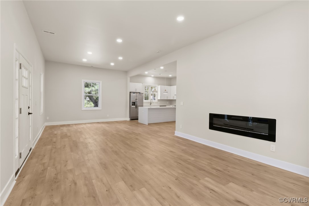 10614 Rives Avenue McKenney, VA 23872 - Photo 6 of 48 an empty room with wooden floor and windows