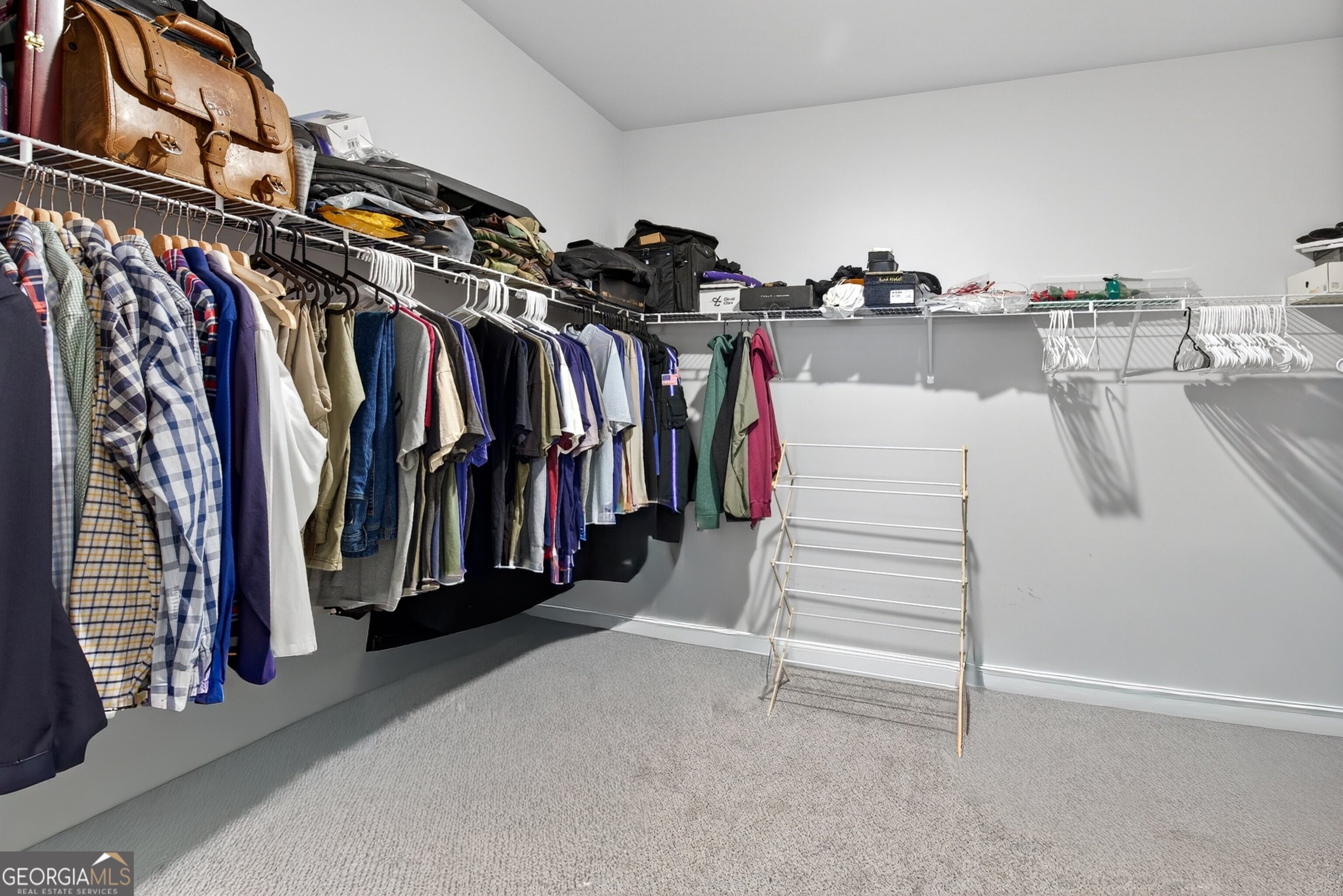 1764 Luther Bailey Road Senoia, GA 30276 - Photo 26 of 63 a view of walk in closet with clothes and shoes
