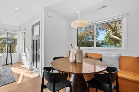 a large white kitchen with a sink and dishwasher a stove with wooden floor
