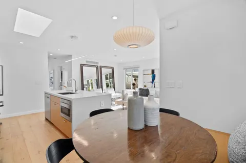 a bedroom with two beds and a painting on the wall