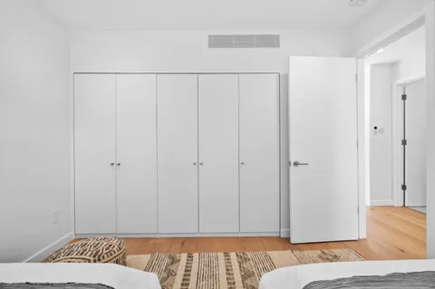 a bedroom with a bed and a lamp