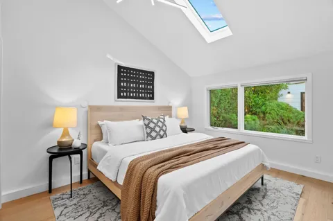 a bedroom with a bed and a chandelier