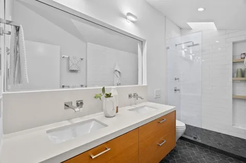 a view of a patio with table and chairs with wooden floor and fence