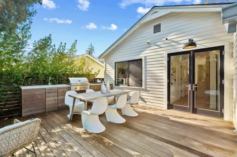 a view of house with backyard and seating area