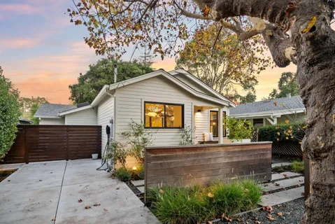 a patio with wooden table and chairs