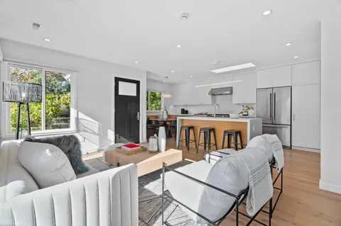 a living room with furniture a fireplace and a large window