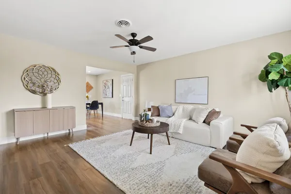 a living room with furniture and a wooden floor