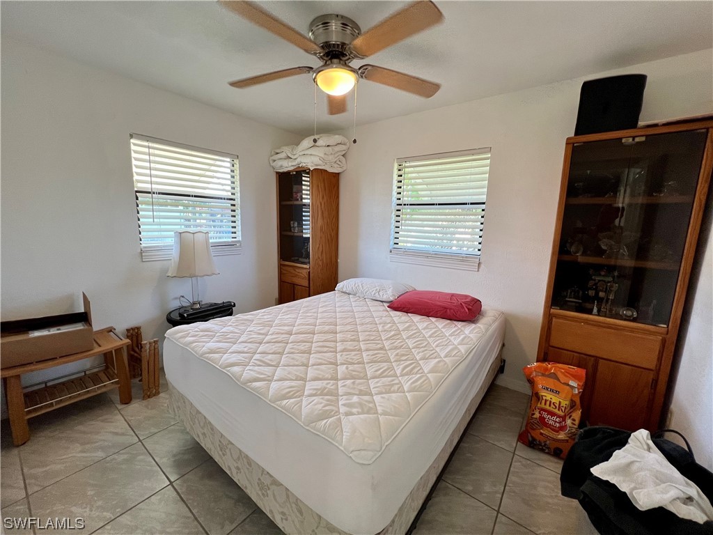 24 Alabama Road South Lehigh Acres, FL 33936 - Photo 11 of 17 a bedroom with a bed and a television